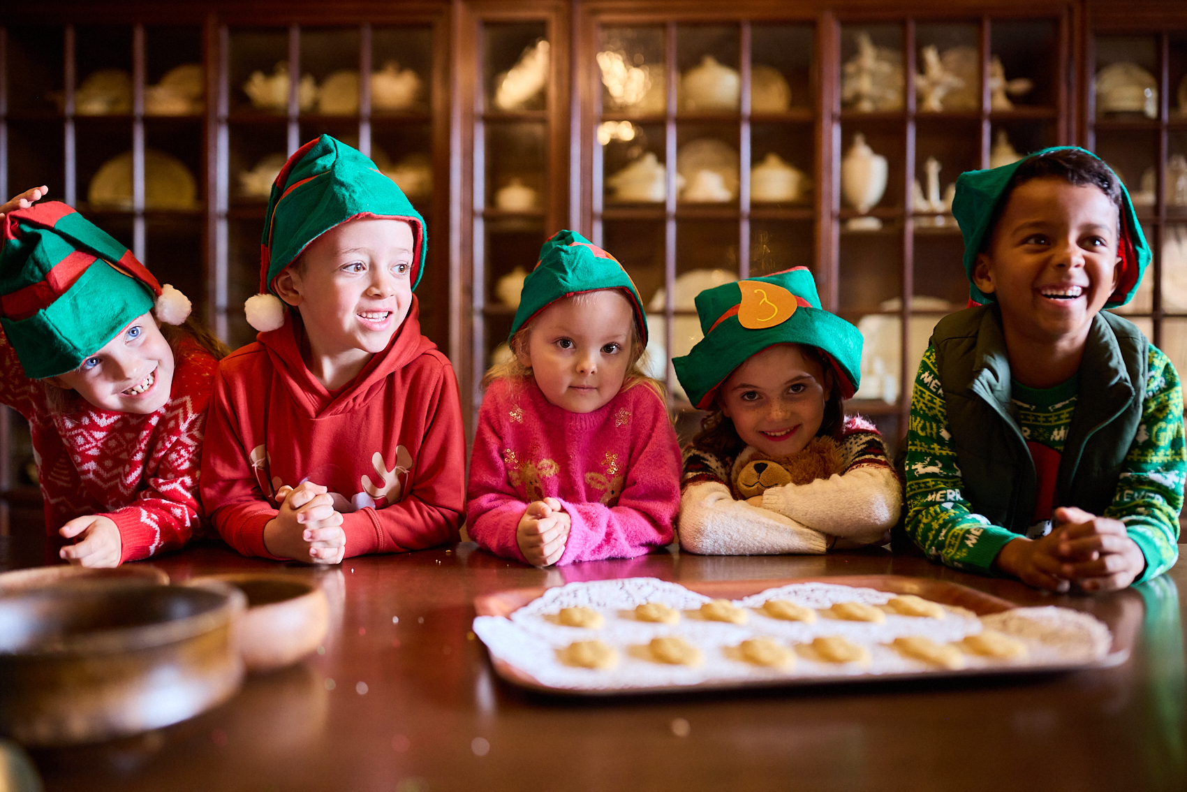 Photograph of a group of five children dressed as elves.